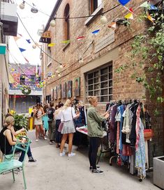 people are shopping at an outdoor clothing store