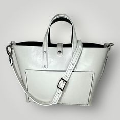 The Taylor Handbag is the epitome of classic and timeless style. It is crafted from high-quality Italian leather with elegant white edging. It features both hand and shoulder straps, providing versatility for any occasion. Convenient inside and outside pockets offer ample storage for all your essentials. Measures: 42cm wide x 27cm long x 13cm deep Classic Tote Box Bag For Errands, Classic Rectangular Box Bag For Errands, Classic Box Bag With Double Handle For Errands, Classic Double Handle Box Bag For Errands, Classic Top Handle Bag For Errands, Classic Handheld Bucket Bag For Shopping, Classic Handheld Bucket Bag, Classic Tote Satchel With Removable Pouch, Classic Satchel With Double Handle For Daily Use