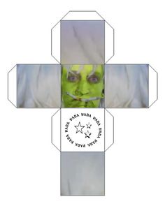 an origami cross with the face of a person wearing green makeup