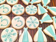 decorated cookies on a cooling rack with snowflakes and numbers in the middle,