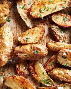 roasted potatoes with herbs and seasoning on a baking sheet