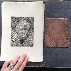 a hand holding a piece of wood next to two drawings