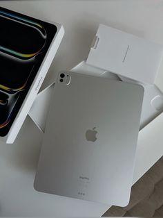 an apple ipad in its box next to it's packaging on a white table