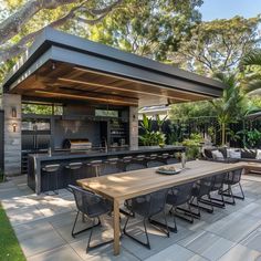 an outdoor kitchen and dining area is shown