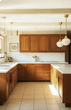 a kitchen filled with lots of wooden cabinets and white counter top space next to a window