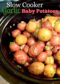 a slow cooker filled with baby potatoes and garnished with green parsley