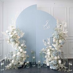 a large mirror with flowers and candles on it in front of a wall that says g