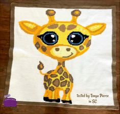 a cross stitch picture of a giraffe with big eyes