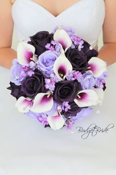 a bridal bouquet with purple and white flowers in the bride's hand,