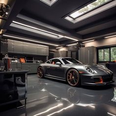 a black car parked in a garage with orange rims on the front and sides