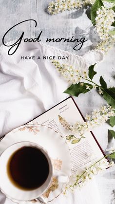 a cup of coffee sitting on top of a saucer next to an open book