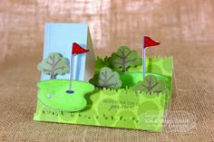 an origami golf hole and flag holder