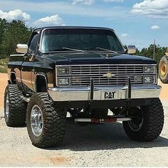 a large truck parked on top of a dirt field