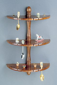 three tiered wooden shelf with toy figurines on it and key hooks hanging from the top