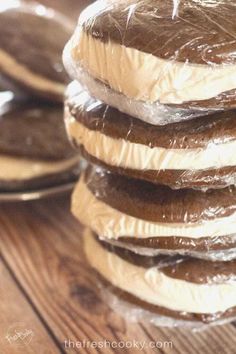 a stack of chocolate covered cookies sitting on top of a wooden table