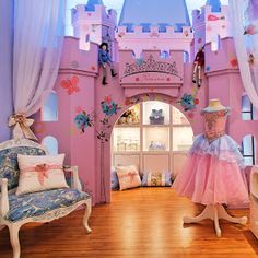 a pink princess's room with furniture and accessories on display in front of the window