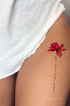 a woman's thigh with a flower tattoo on it