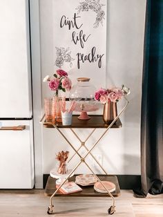 a table with flowers and plates on it in front of a sign that says don't be picky