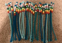 several different colored toothbrushes lined up on the floor