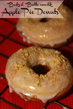 two glazed donuts sitting on top of a cooling rack