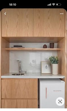 a small kitchen with wooden cabinets and white counter tops, including a dishwasher