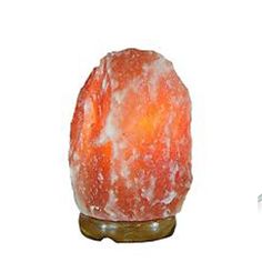 an orange himalayan salt lamp on a wooden stand