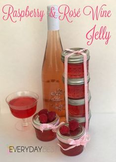 raspberry and rose wine jelly in mason jars next to a bottle of wine