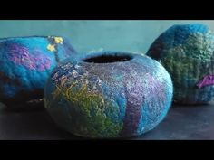 three colorful vases sitting on top of a table