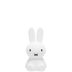 a white rabbit toy sitting on top of a table