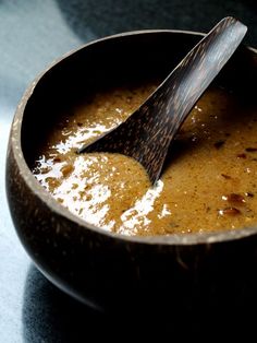 a wooden bowl filled with food and a spoon