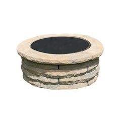 a round stone fire pit with a black cover on it's side, set against a white background