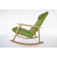 a wooden rocking chair with green fabric on the seat and back cushion, in front of a white background