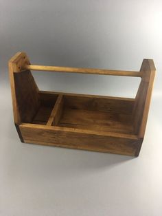 an empty wooden box with handles on a white background