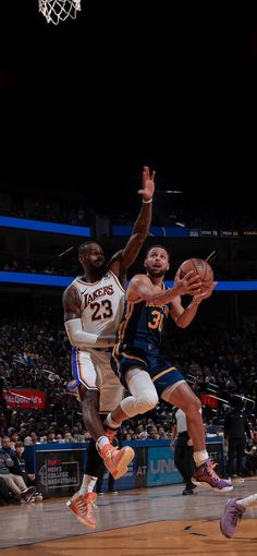 two basketball players in action on the court