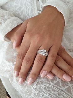 a close up of a person's hand with a wedding ring on their finger