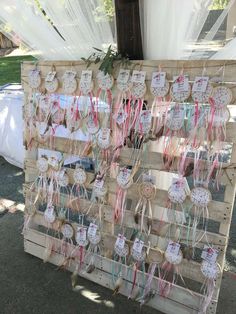 there are many different items on the wooden board for sale at this event, such as buttons and ribbons