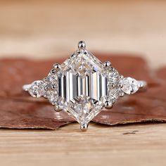 A sparkling hexagon diamond ring set on a slender band, perfect for an engagement or special occasion Elongated Hexagon Engagement Ring, Ring Goals, Hexagon Diamond Ring, Hexagon Engagement Ring, Rose Cut Ring, Moissanite Vs Diamond, Colored Diamond Rings, Hexagon Diamond, Antique Diamond Rings