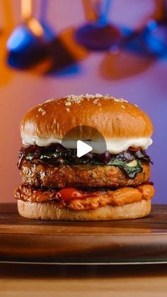 a hamburger sitting on top of a wooden cutting board