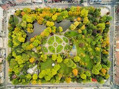 an aerial view of a park in the middle of a city with lots of trees