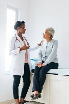 an older woman is talking to a doctor