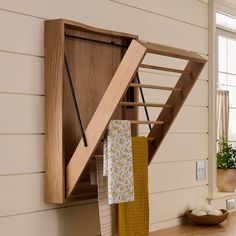 a wooden shelf with clothes hanging from it