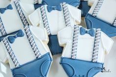 blue and white decorated cookies in the shape of baby's diapers with bow ties