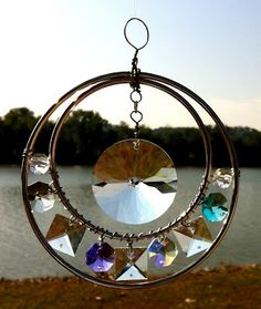 a wind chime hanging from the side of a body of water