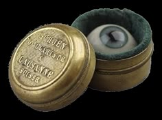 an eyeball in a small gold box