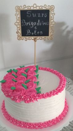 a white cake with pink and green frosting