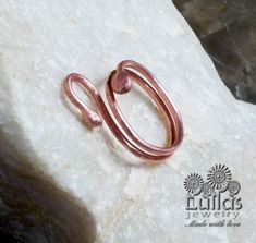 a copper ring sitting on top of a rock