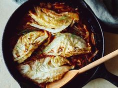 an iron skillet filled with cabbage and meat