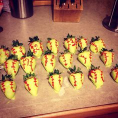 chocolate covered strawberries are arranged in the shape of baseballs on a counter top