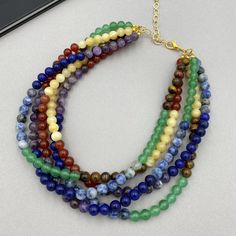 This colorful gemstones statement necklace features chunky multi color beads arranged in a stunning multi strand design. Vibrant and elegant, it's a perfect accessory to brighten up any outfit and a thoughtful gift for her, ideal for any occasion. - Necklace length is 17" long plus additional 4 inches extender chain for length adjustment. Made from natural mixed gemstones beads. - non tarnish gold plated finding - clasp is gold plated stainless steel lobster claw - 4 inches extender is non tarnish gold plated textured chain This necklace would be a PERFECT GIFT for you or for your family and friends!  Comes beautifully packaged in a gift box!  Thank you for your visit! Halloween, Halloween jewelry, Fall Autumn necklace, Handmade jewelry, Christmas Gifts, Christmas Necklace, mixed gemstones Color Beaded Necklace, Mixed Stone Necklace, Autumn Necklace, Multi Coloured Necklaces, Colorful Gemstones, Thoughtful Gifts For Her, Christmas Necklace, Rainbow Necklace, Necklace Chunky