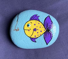 a painted rock with a fish on it